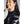Woman wearing a black 8K FlexWarm quilted vest over a grey sweater