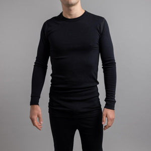Man wearing a black Merino Skins long sleeve thermal crew neck top