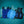 AlphaCool cooling vests in blue and black with ice cubes on a teal background