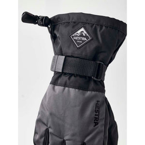 Black Hestra ski mitten with adjustable wrist strap and mountain logo patch