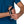 Person wearing a black handheld running water bottle strap