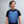 Man wearing an AlphaCool blue gel cooling vest over a black t-shirt