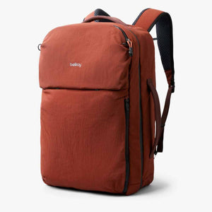 Bellroy rust colored backpack with side handle and shoulder straps