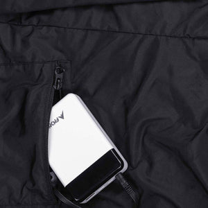 FNDN power bank plugged into a zippered pocket on a black garment