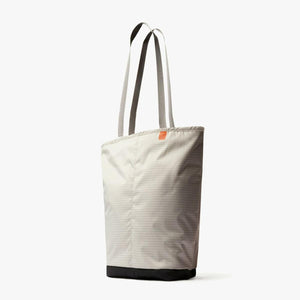 Beige tote bag with grid pattern and black base