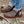 Acorn slipper with brown wool texture and owl embroidery on a wooden surface