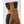 Close up of brown suede and black fabric glove cuff with pink stitching
