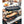 Snow Peak cast iron oval skillet cooking fish with lemon slices over a charcoal grill