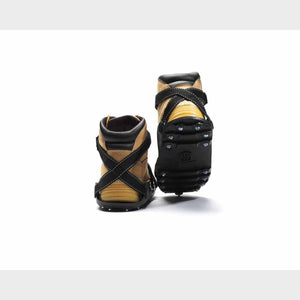 Tan boots with black ice cleats attached to the soles