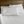 Shavel white bed sheets and pillowcases on a bed with a wooden headboard