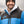 Man wearing a Detroit Lions branded black and blue puffer jacket over a grey hoodie and a black beanie