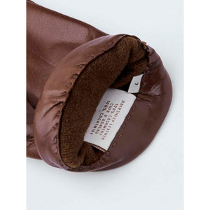 Interior label of Hestra brown leather glove showing material composition