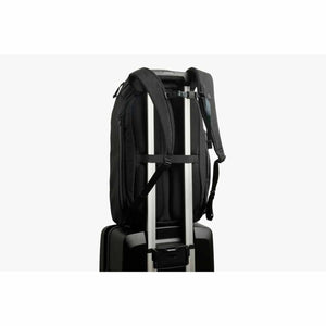 Bellroy black backpack attached to luggage handle