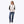 Woman wearing a white Mobile Warming fleece vest over a black and white striped long sleeve shirt and blue jeans