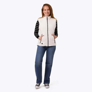 Woman wearing a white Mobile Warming fleece vest over a black and white striped long sleeve shirt and blue jeans