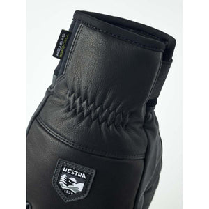 Black Hestra leather glove with elasticated wrist and trigger system label