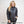 Woman wearing a black Venture Heat quilted jacket with a front zipper and logo