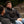 Man wearing a black ActionHeat Steelers heated vest sitting on a park bench