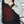 Person wearing a Venture Heat black heated vest with visible red heating elements