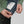 Hands adjusting the drawstring hem on a Fjallraven Expedition jacket with an interior story label