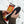 Hands holding a Grabber foot warmer insole package against a snowy background