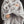 Person wrapped in a Beautyrest faux fur throw blanket with white and grey mottled pattern