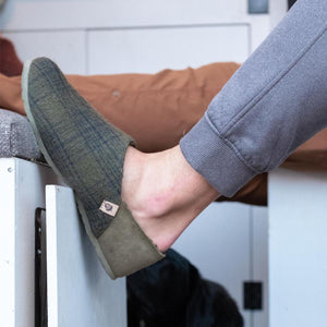 Acorn olive green plaid wool slipper on a foot