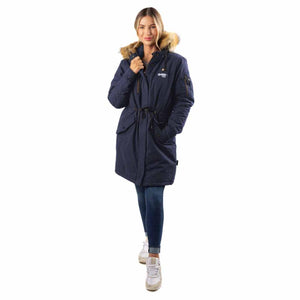 Woman wearing a navy blue Gobi Heat parka with a faux fur hood