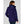 Woman wearing a dark blue Helly Hansen hooded rain jacket from the back