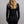 Back view of a person wearing a black Merino Skins long sleeve top