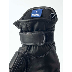Black leather Hestra glove cuff with adjustable velcro strap and size 9 label