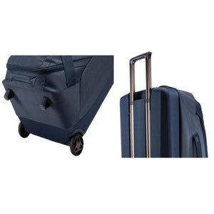 Thule blue rolling luggage showing wheels and extended telescopic handle