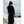 Person wearing black Auclair gloves and winter clothing in a snowy mountain setting