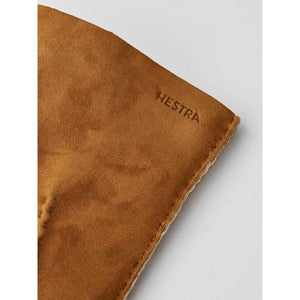 Brown suede Hestra glove detail with embossed logo