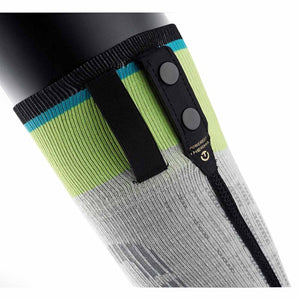 Close up of a grey and lime green compression sleeve with black snap button attachment