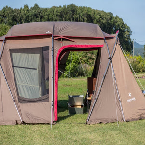 Snow Peak brown camping tent with open entrance on a grassy field
