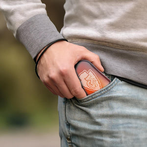 ActionHeat hand warmer with Kansas City Chiefs logo being placed into a jeans pocket