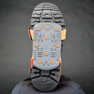 Winter Walking ice cleat attached to the sole of a black boot