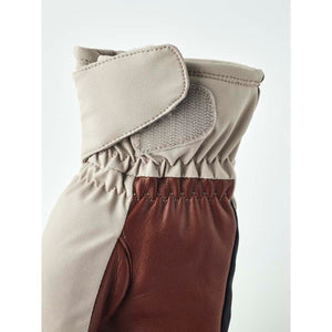 Hestra glove cuff with beige fabric and brown leather detail featuring a velcro closure