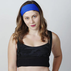 Woman wearing an Oro Sports black chest brace and blue headband