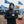 Man wearing ActionHeat jacket and Dallas Cowboys beanie holding a steaming cup at a tailgate
