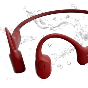 Red Shokz bone conduction headphones surrounded by water splashes