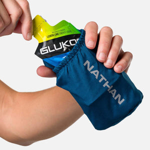 Hand holding a Nathan energy gel flask with Gluko lemon lime energy liquid