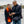Two people wearing ActionHeat heated scarf and vest looking at a smartphone