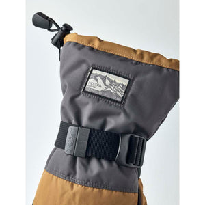 Hestra grey and tan winter glove cuff with adjustable strap and brand logo patch