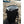 Open AO Coolers black soft cooler bag on a sandy beach