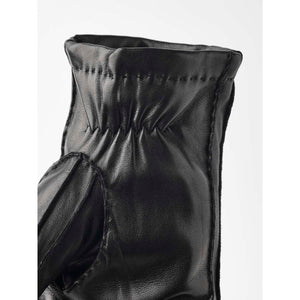 Close up of black Hestra leather glove cuff with elastic detail