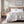Beautyrest faux fur heated throw blanket on a white bed with wooden headboard and nightstand