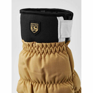 Tan Hestra glove cuff with black neoprene top and white leather strap