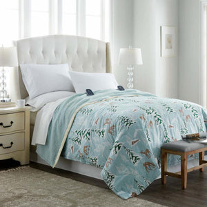 Shavel heated blanket with forest and deer print on a bed